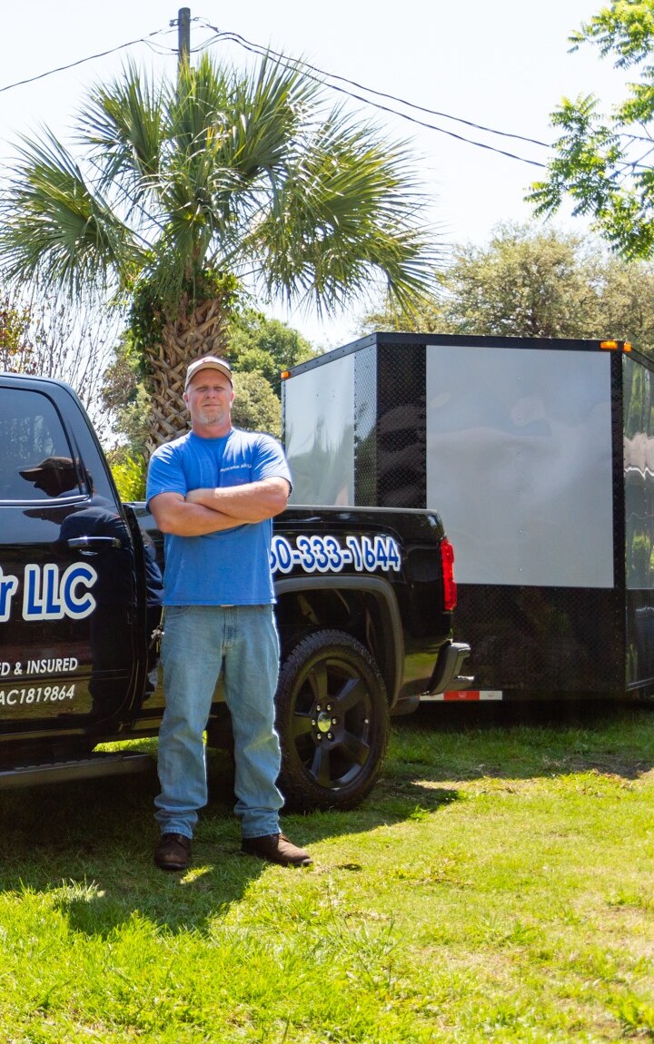 Hurricane Air technician servicing an outdoor AC unit